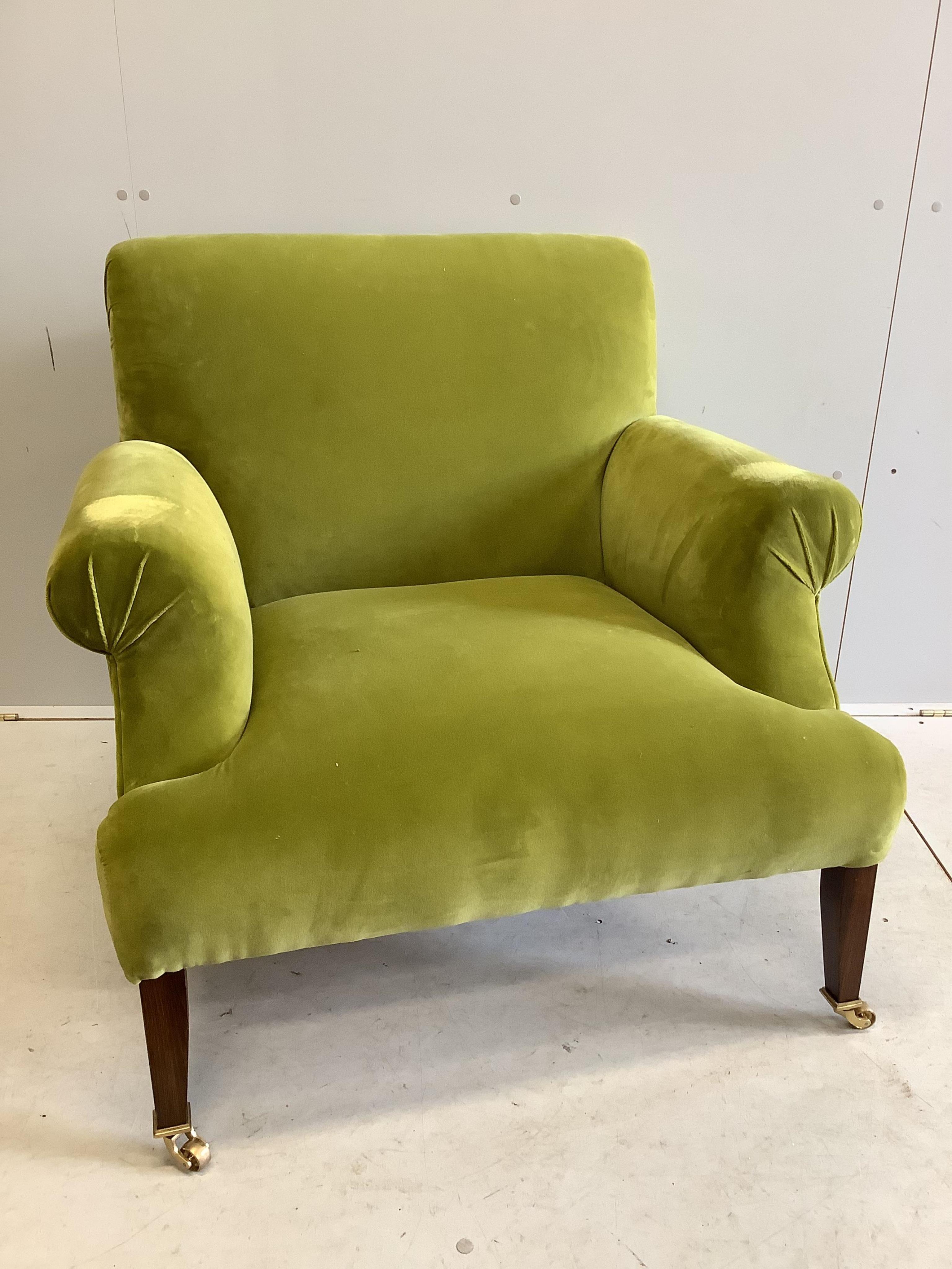 A Howard style green upholstered armchair, width 90cm, depth 80cm, height 84cm. Condition - fair to good